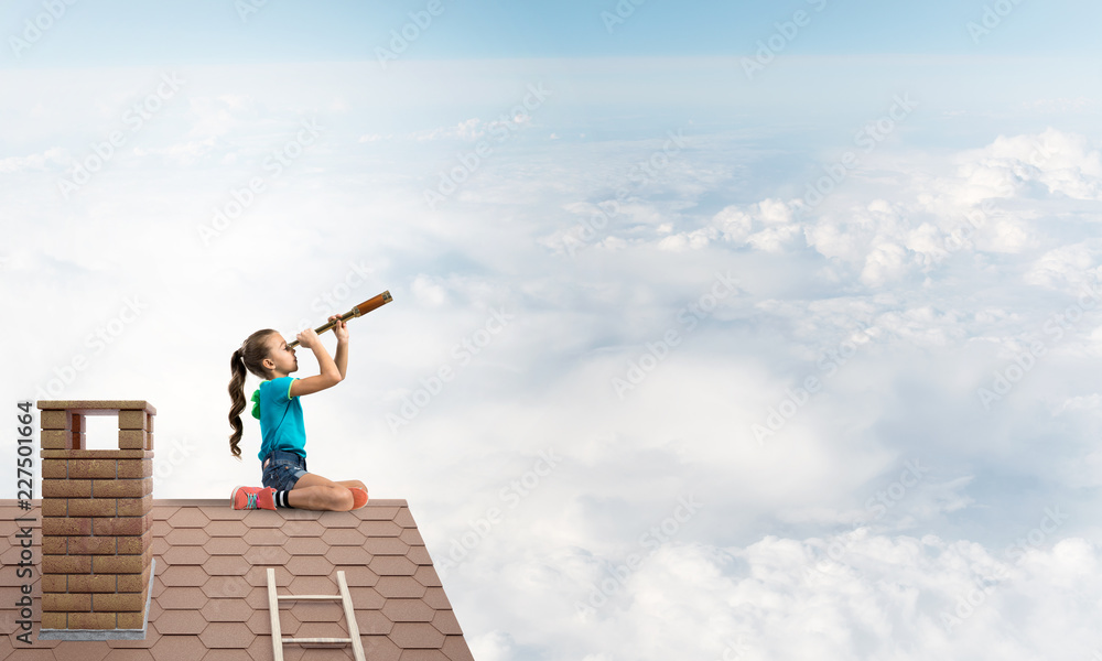 Concept of careless happy childhood with girl looking in spyglass