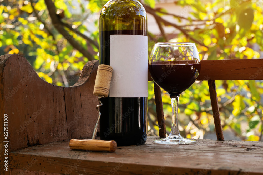 Red Wine Bottle and Wine Glass on Wodden Barrel