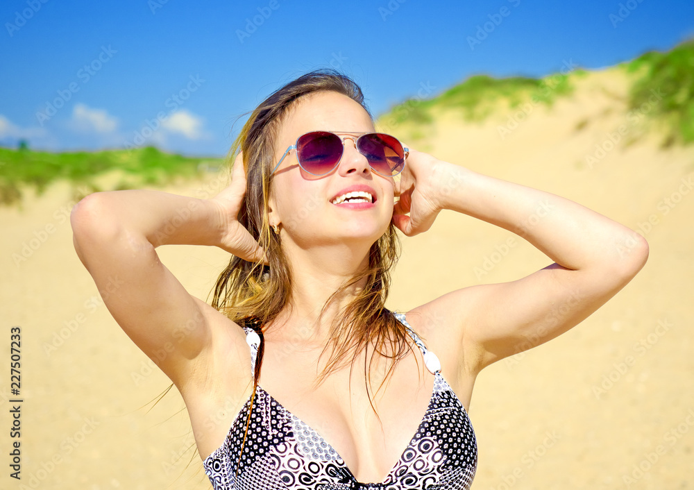 Gorgeous Romantic Woman Long Hair Relaxing on Beach Before Blue Sea Summer Outdoor Holiday Seaside Toned Effect. Beautiful woman having fun on the beach, fashion girl, brunette posing with glasses. Gorgeous Romantic Woman Long Hair Relaxing on Beach Before Blue Sea Summer Outdoor Holiday Seaside Toned Effect. Beautiful woman having fun on the beach, fashion girl, brunette posing with glasses.