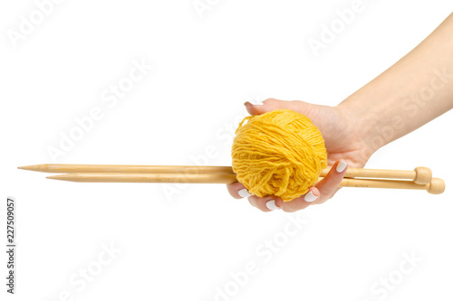 Knitting yarn needles in hand isolated on white background