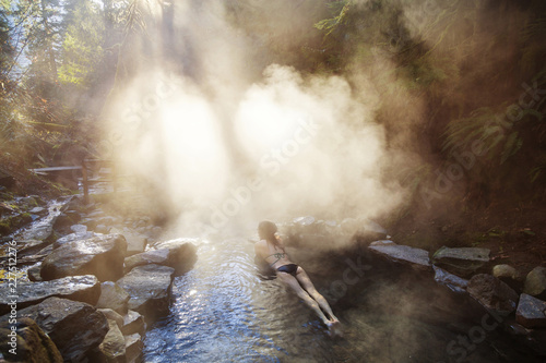Φωτογραφία High angle view of woman relaxing in hot spring at forest