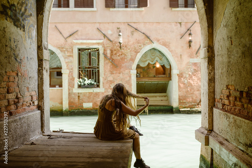 traveling woman in venice italy with long hair
