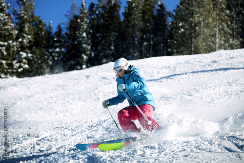 Woman skiing downhill on mountain