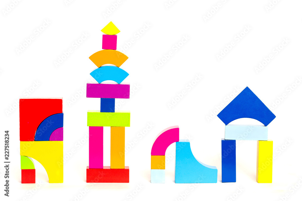 Children's multi-colored wooden blocks cubes toys on a white background. Multicolored figures.