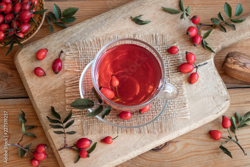 A cup of rose hip tea with fresh rose hips