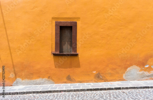 Street view in Mexico on sunny day with traditional architecture window