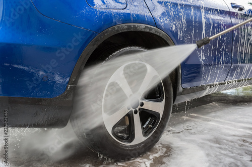 Car Washing. Cleaning Car Using High Pressure Water. Autowashing outdoors photo