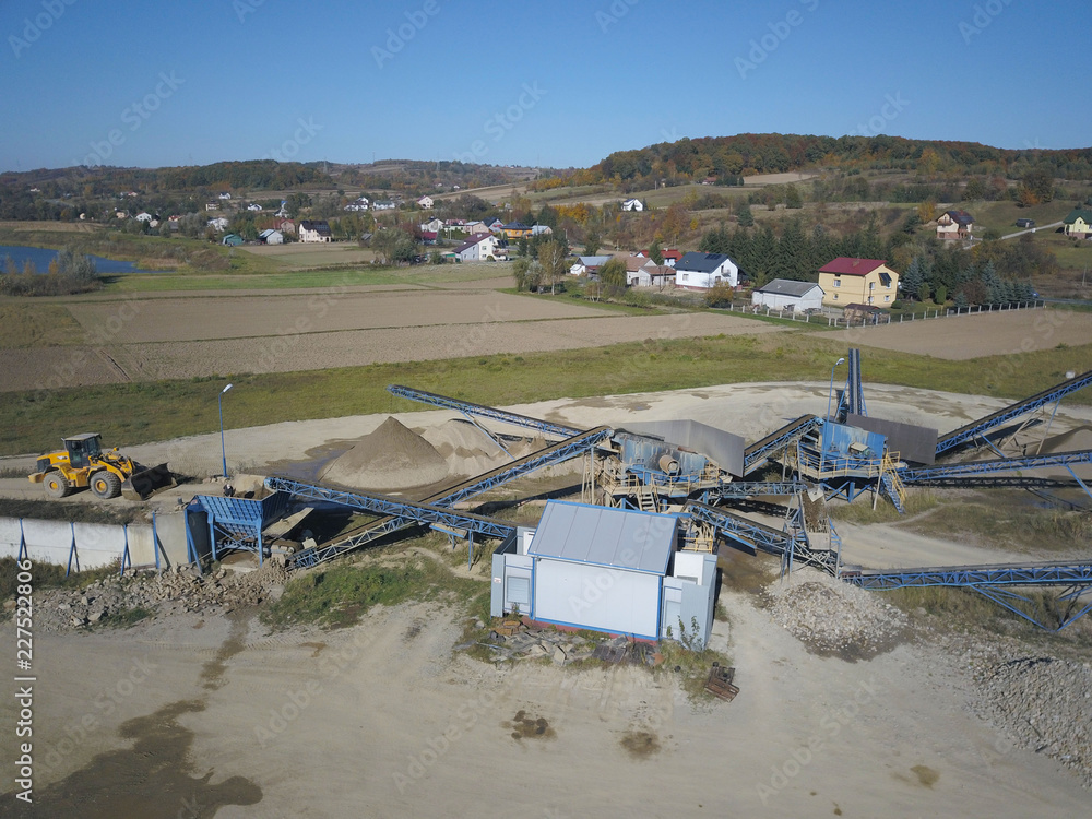 Extraction, washing, sorting and distraction of river gravel. Mining industry. Technology of obtaining a stone. A bird's eye view. Shooting with a quadrocopter. Metal construction of sorting of rubble