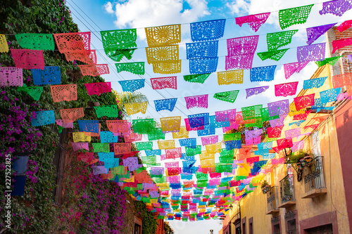 Colorful paper flags over street photo