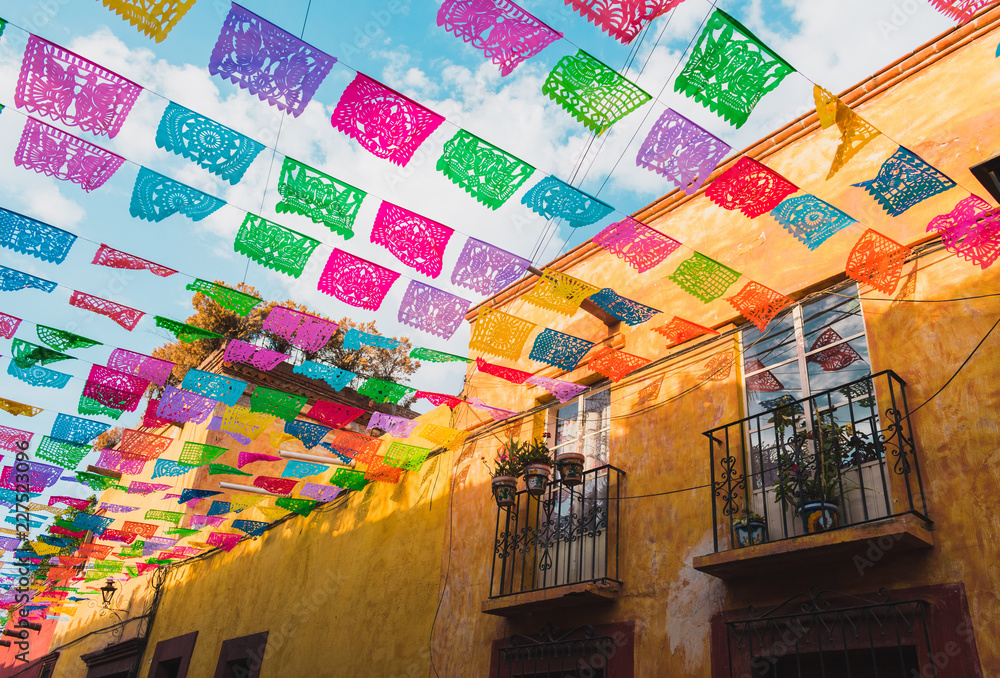 Colorful paper flags over street Colorful paper flags over street