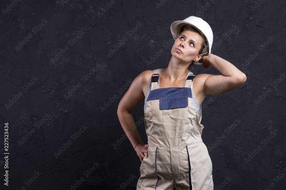 Portrait of beautiful woman worker builder in uniform with white helmet Portrait of beautiful woman worker builder in uniform with white helmet
