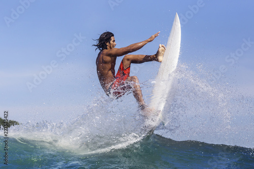 Photography Young man surfing at ocean