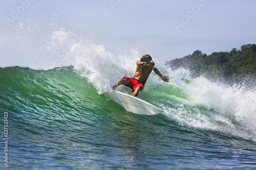Young man surfing at ocean
