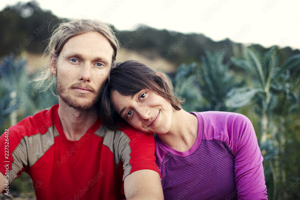 Fototapeta premium Portrait of couple sitting at farm