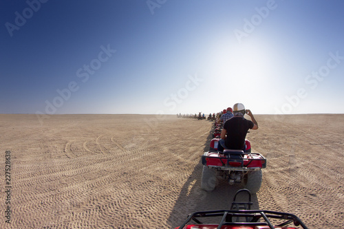 Vászonkép Row of beach buggies in barren landscape