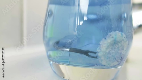 Cleaning tablet disolves in a glass of water cleaning mouth guard 
 photo