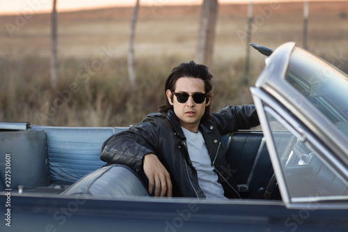 Tablou pe pânză Portrait of young man in convertible