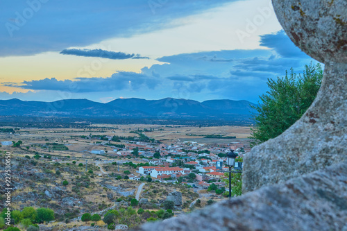 Beautiful view of the village with houses and roads and mountains background with a cloudy sunset in Las Ventas with Peña Aguilera, Toledo, Castilla La Mancha, Spain photo