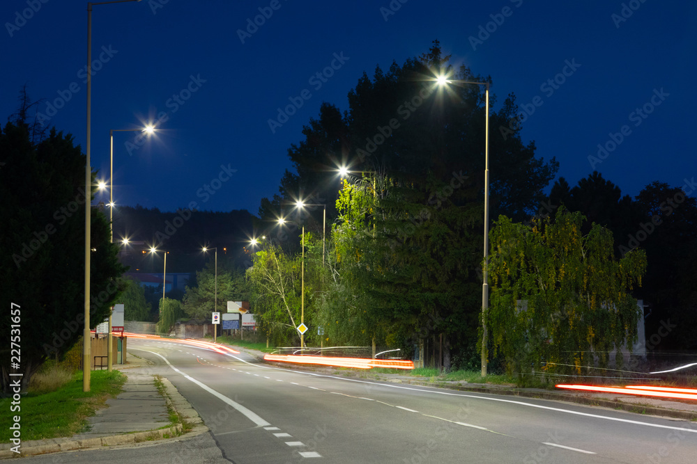 night empty road with modern LED street lights, entrance to a small town