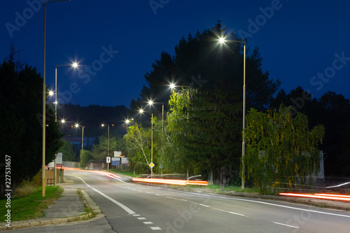 Fototapeta Naklejka Na Ścianę i Meble -  night empty road with modern LED street lights, entrance to a small town