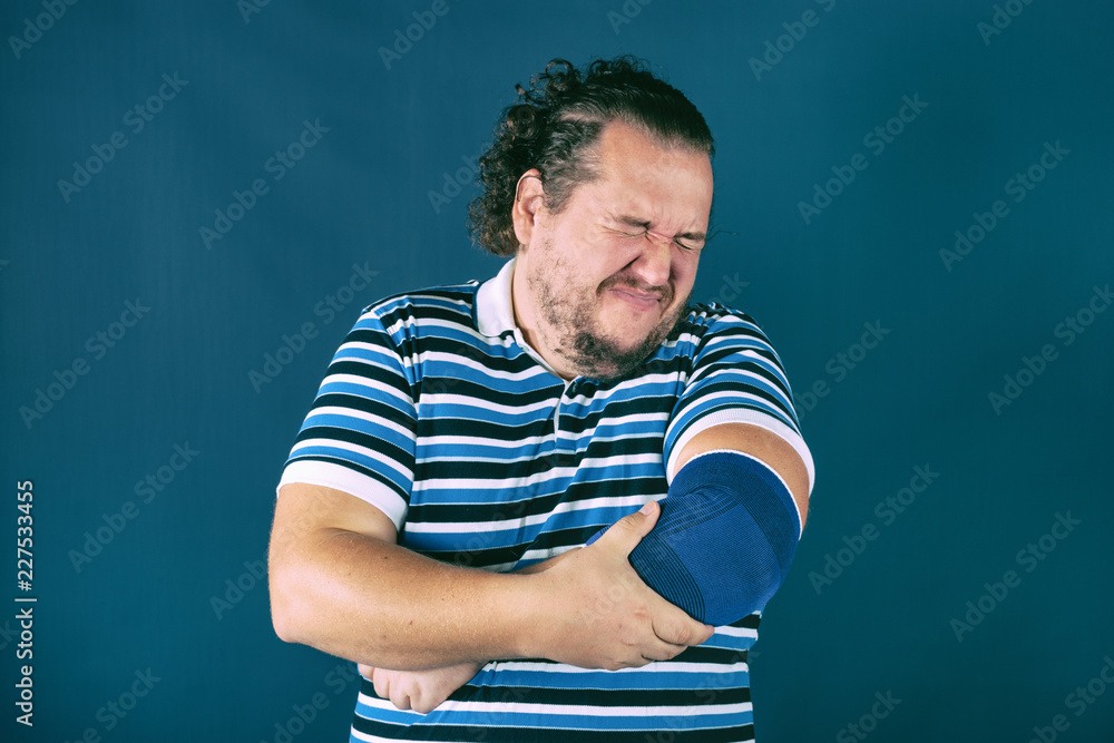 Man holding his sore elbow. Health problems Man holding his sore elbow. Health problems