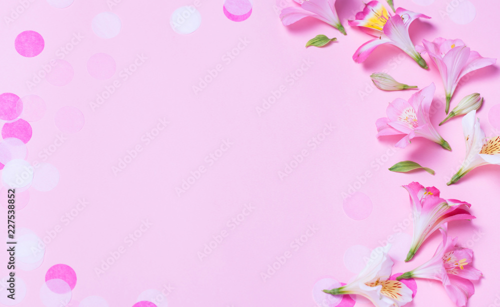 beautiful frame made from pink flowers and pink confetti on pink background. beautiful frame made from pink flowers and pink confetti on pink background.