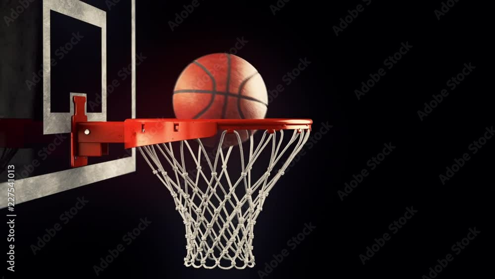 A throw basketball ball in a ring on a black background A throw basketball ball in a ring on a black background