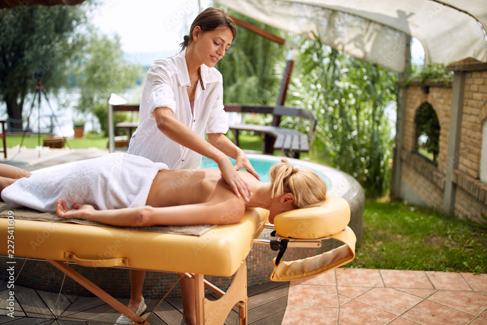 Massage - woman in spa salon on outdoor getting massage.