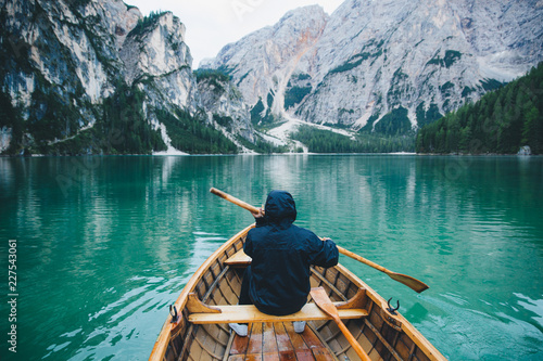 Man Aboard Wooden Boat in Italian Alpine Lake photo