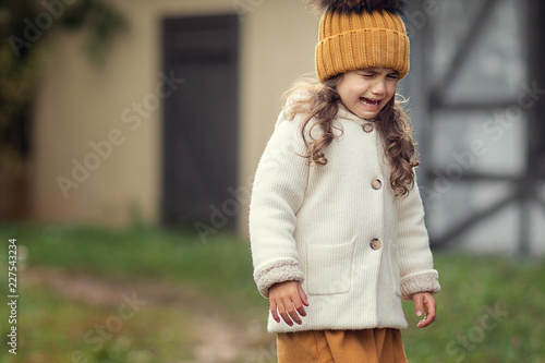 adorable girl crying outdoors