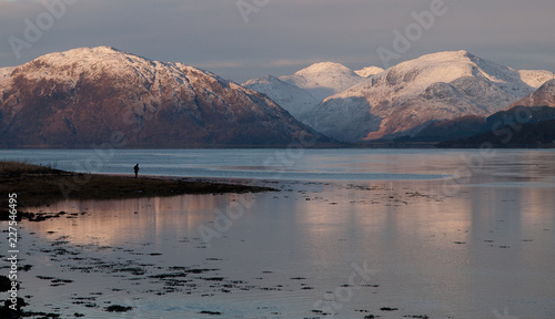 A person contemplates the beautiful view of the western highlands of scotland photo