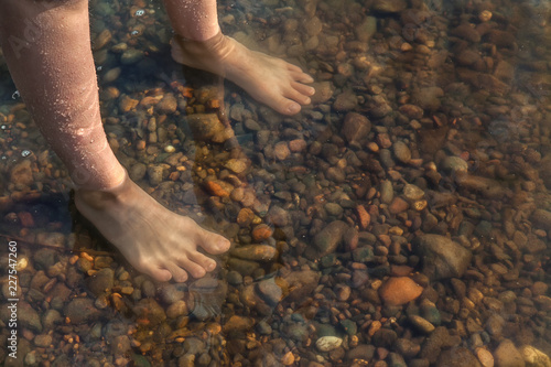 feet in the water standing
