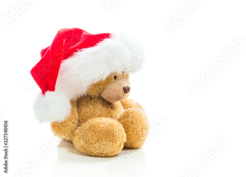 Teddy bear with a Santa hat isolated on white background © Tierney