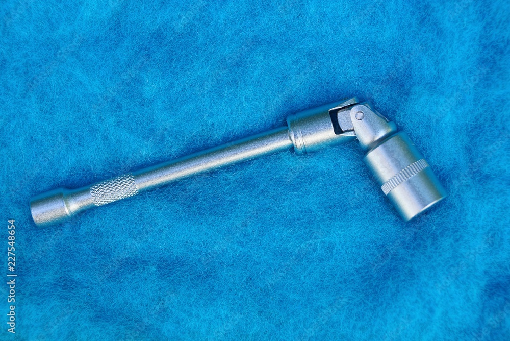 gray iron tool with socket head on blue wool gray iron tool with socket head on blue wool