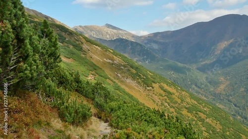 Pan over Ostry rohac the rdigeline and baranec from a trail. (Western, Tatra, Slovakia) photo