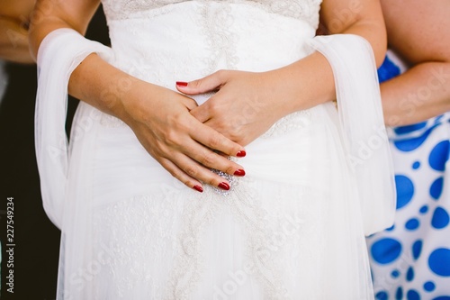Detail of a white and elegant wedding dress.