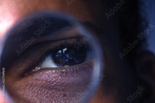 eye through magnifying glass