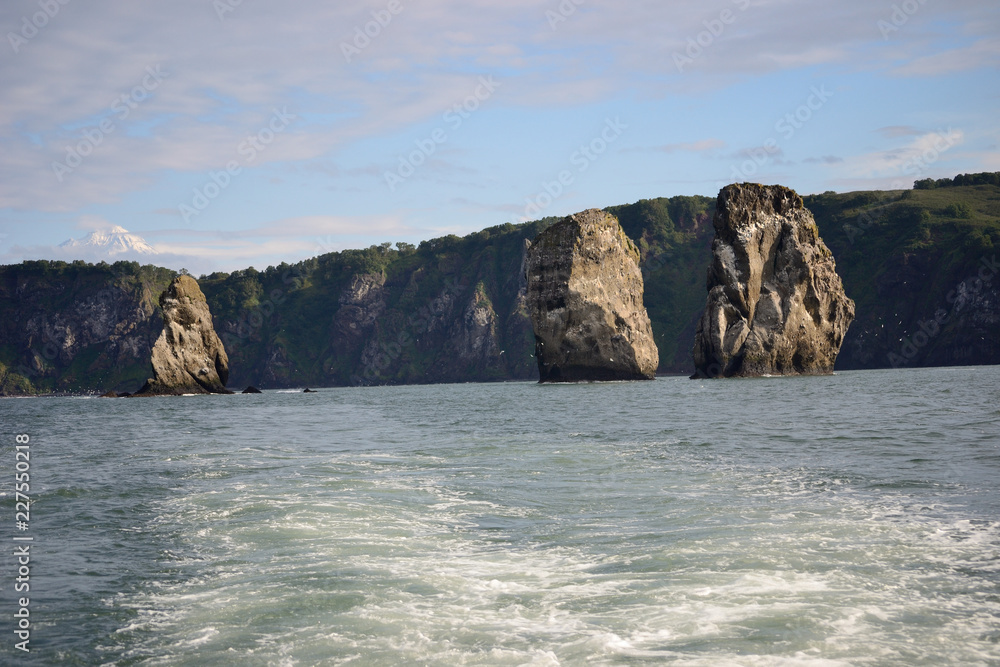 View to rocks Tri Brata (Three brothers) from water, Kamchatka