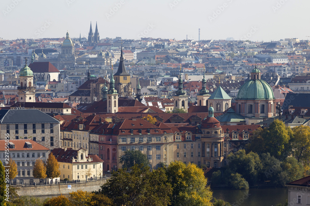 Obraz premium Autumn Prague City with with its Buildings, Towers, Cathedrals and Bridges in the sunny Day, Czech Republic