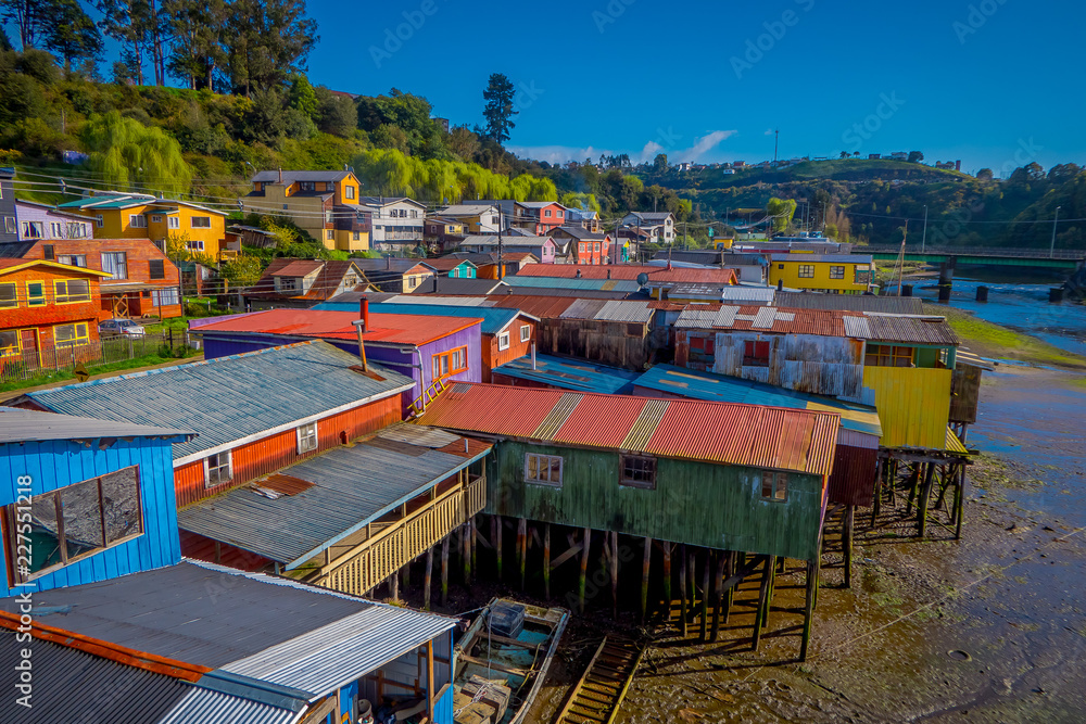 Above beautiful and colorful houses on stilts palafitos in Castro, Chiloe Island