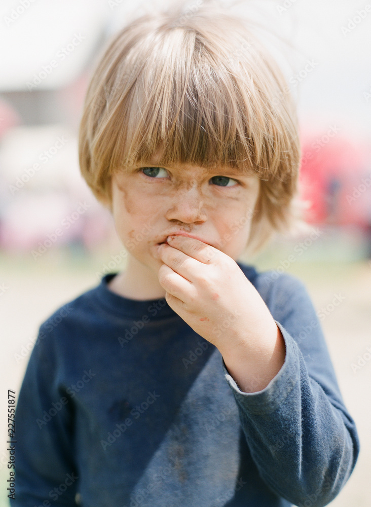 Little Boy Eats Outside With Dirty Face Stock Photo | Adobe Stock