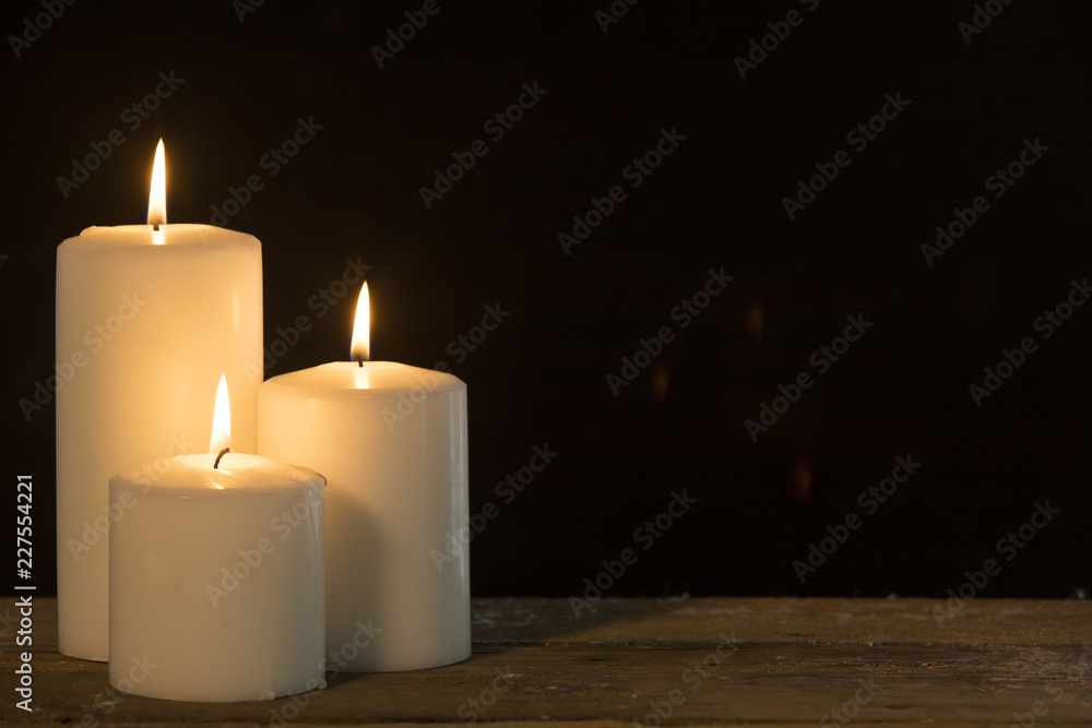 Christmas candles glowing on the table Christmas candles glowing on the table