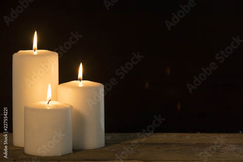 Christmas candles glowing on the table © Creativa Images