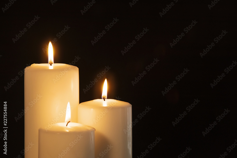Christmas white candles in the dark background