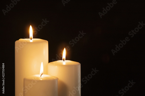 Christmas white candles in the dark background