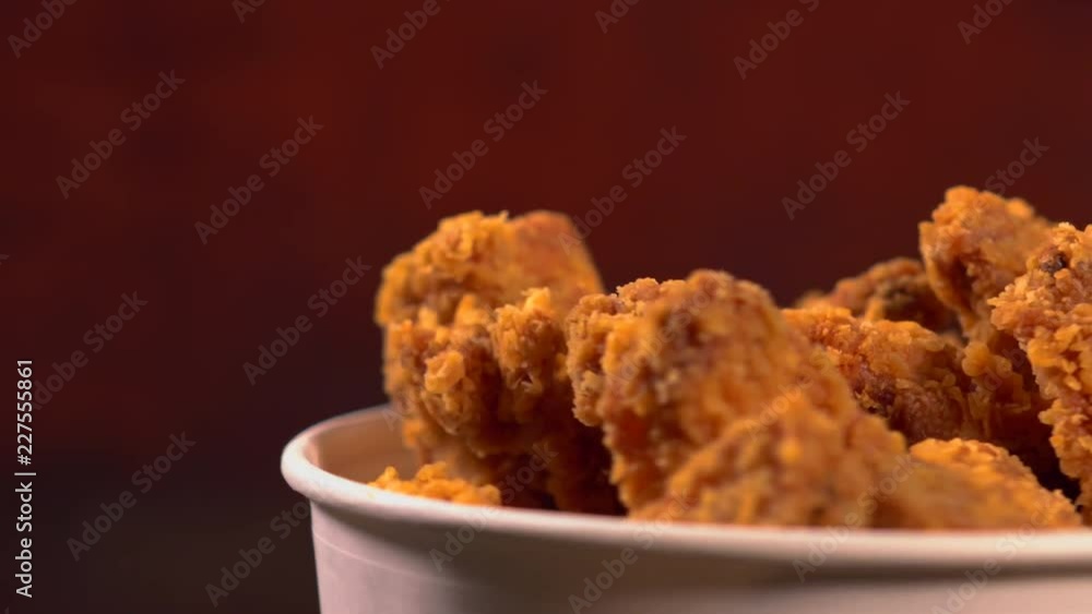 Takeaway tub filled with crumbed chicken pieces Takeaway tub filled with crumbed chicken pieces