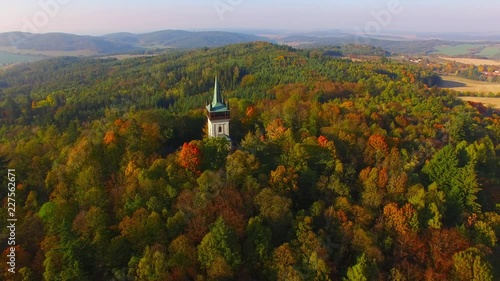 erial view to The Bolfanek viewtower with the St. Wolfgang´s cemetery chapel. Near a  marvelous village Chudenice from 12th century. Czech landmarks from above. Autumn in Central Europe. photo