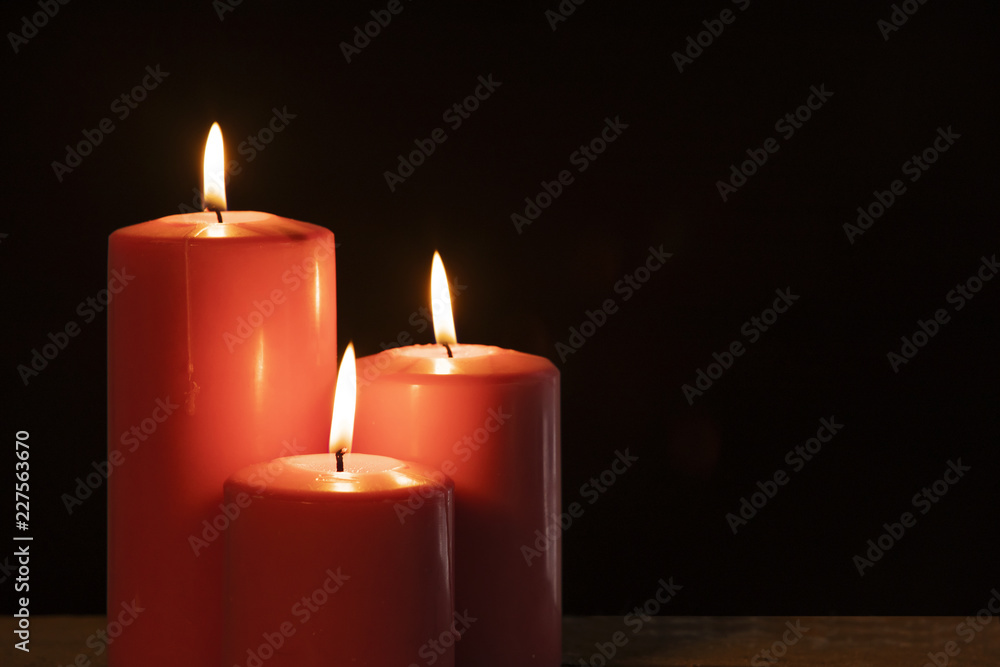 Three burning candles with dark background Three burning candles with dark background