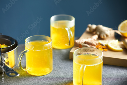 Asian infusion with turmeric, lemon and ginger in glasses. photo