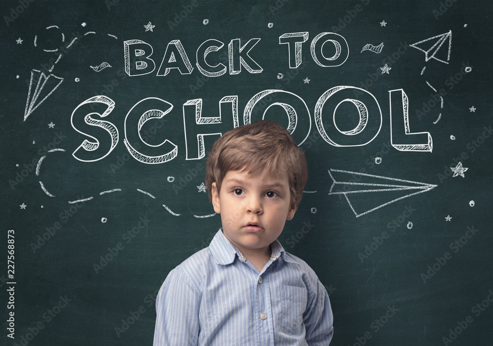 Adorable little boy with blackboard and back to school concept Adorable little boy with blackboard and back to school concept